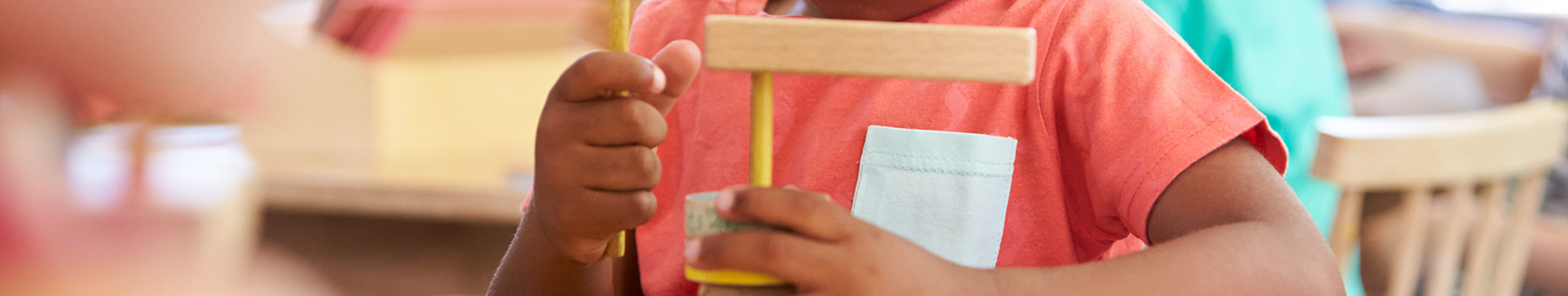 a boy playing with wooden blocks