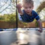 a boy bouncing on a trampoline