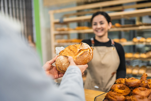 a woman selling sourdough bread