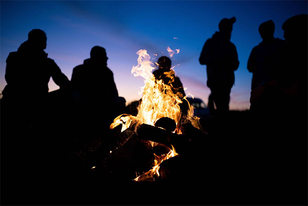 people standing around a fire