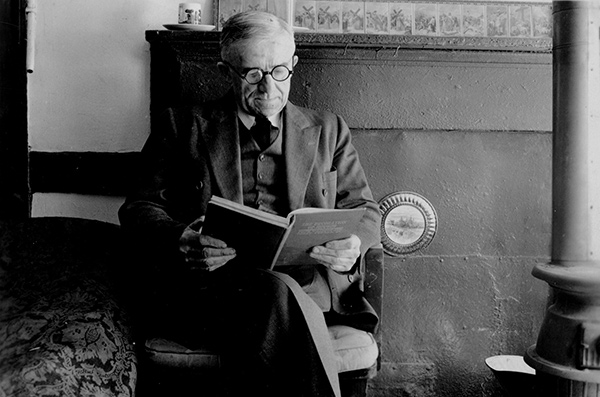 Peter Maurin reading a book