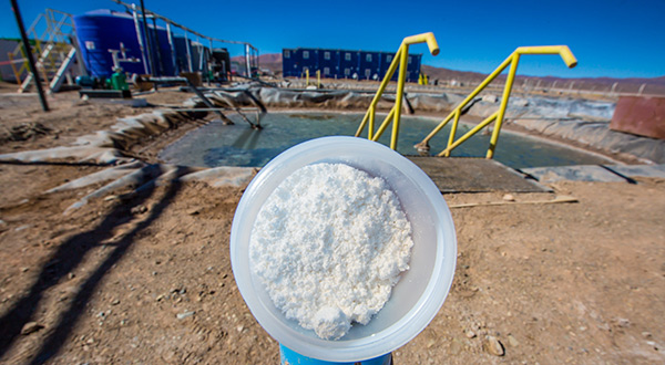 lithium in a container photographed in front of an evaporation pool