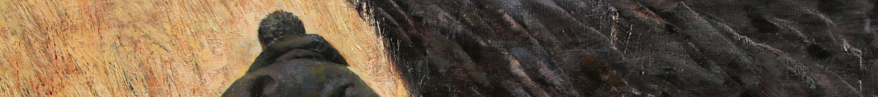 man walking past plowed field