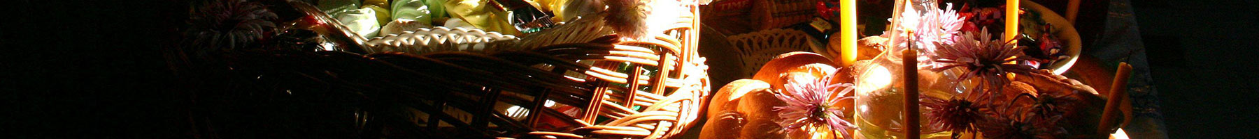 candles burning by baskets of bread