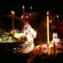 candles burning by baskets of bread