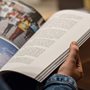 a person reading a magazine