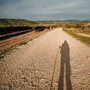 shadow of a pilgrim on a dusty road