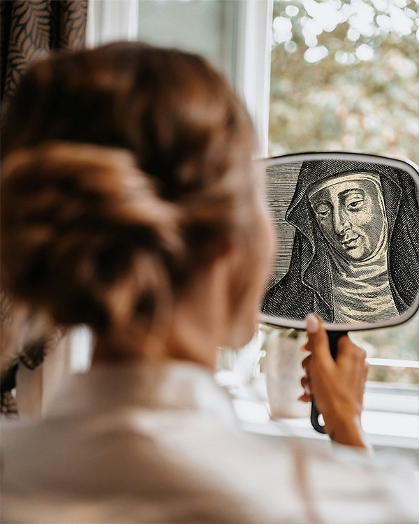 a women looking at a reflection of Hildegard von Bingen in a mirror