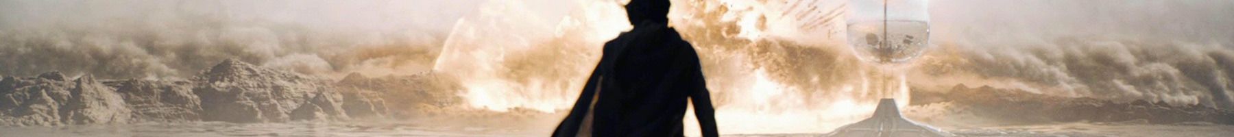 silhouette of a man standing in a desert landscape