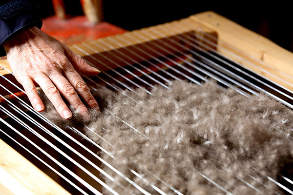 a woman demonstrating eiderdown processing
