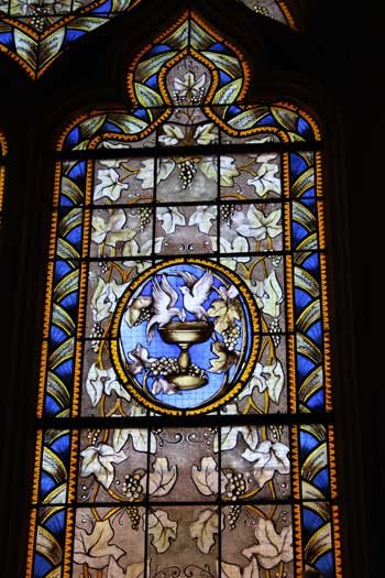 A stained-glass window with doves in the center