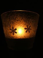 Gold glass with a candle glowing inside