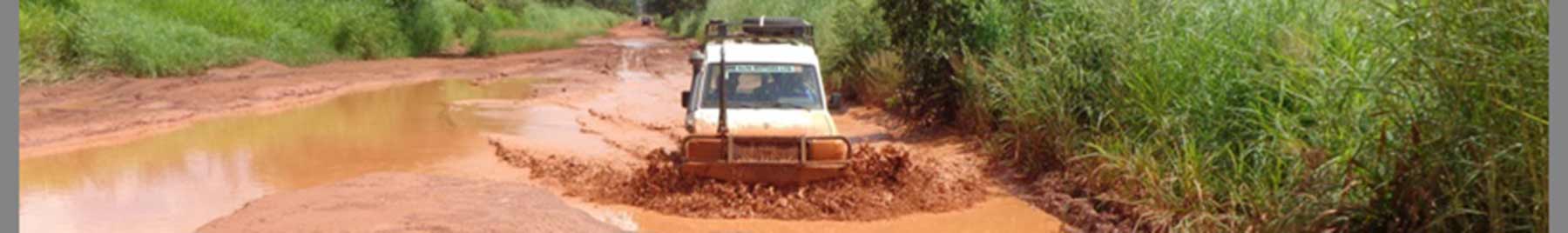 Jeep driving through red dirt in Africa