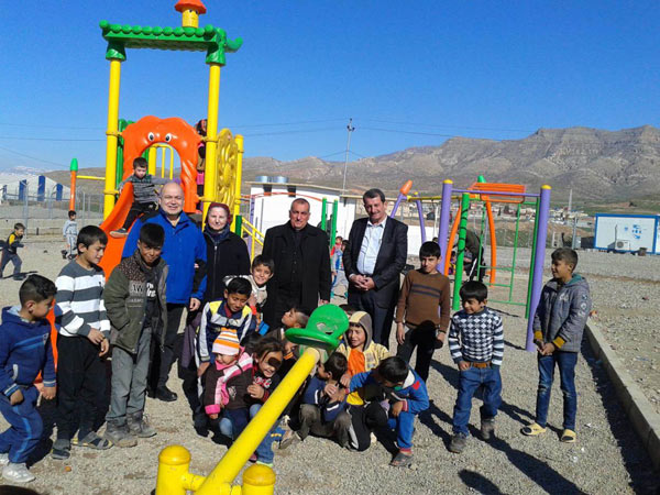Children play on a see saw at a yezidi camp in Iraq.