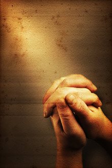 light shining on praying hands