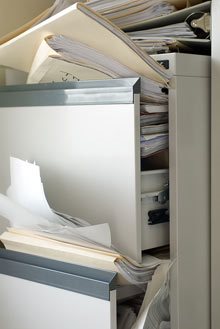 a messy open filing cabinet