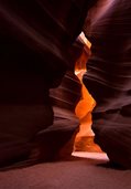orange light shining between mauve rocks in Antelope Canyon in Arizona