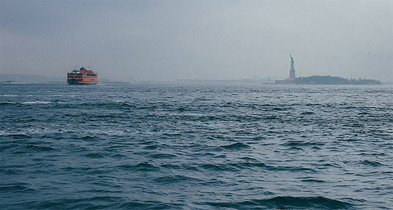 The Statue of Liberty, seen from across the waters of New York's Upper Bay.