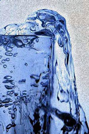 An overflowing glass of water.