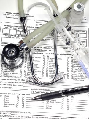Medical reports, stethascope and syringes