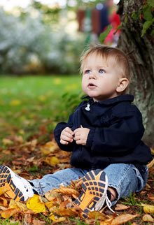 A baby in the Autumn leaves