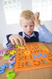 Boy trying to solve a puzzle