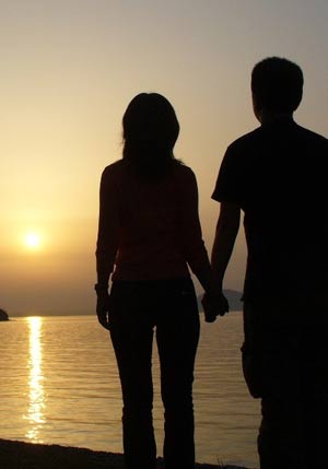 silhouette of a couple at sunset over the ocean