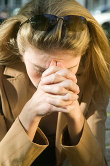 woman with head in hands