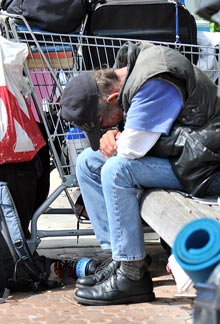 homeless man on a park bench