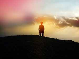 silouette of man against a sunset
