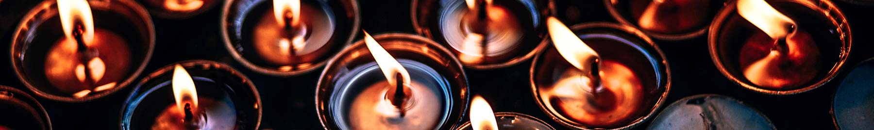 many small candles burning in the dark many small candles burning in the dark