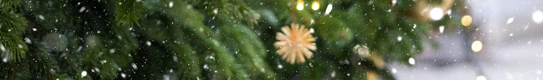 snow falling on a Christmas tree