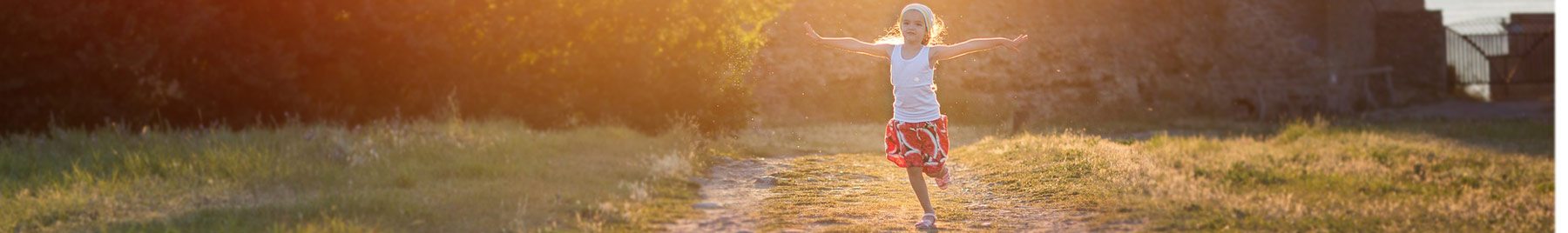 Girl running outside on a dirt road in the early morning
