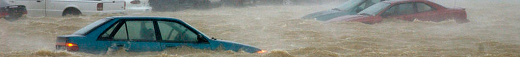 blue car half submerged in flood waters