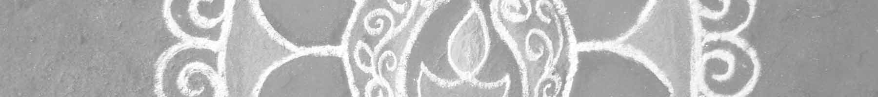 A slice from an Indian rangoli chalk drawing, showing a candle flame.