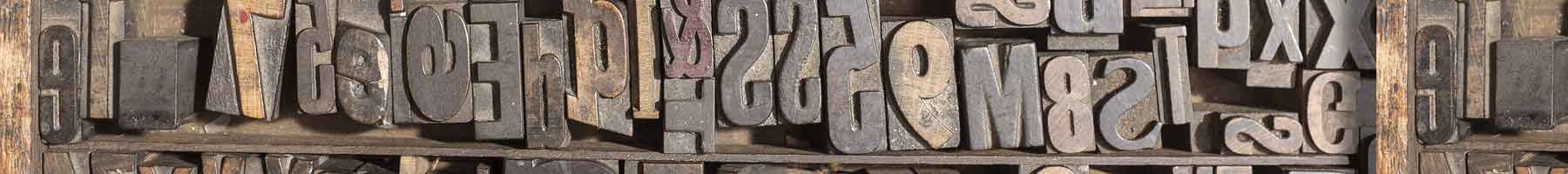 Old wooden type on a wooden shelf