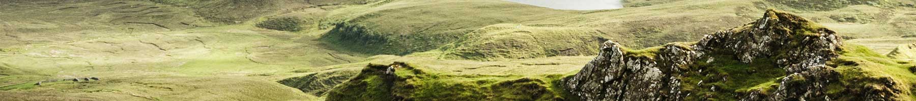 a rocky hill and meadow on the Isle of Skye, Scotland