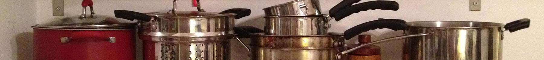 Pots and pans on a kitchen shelf.