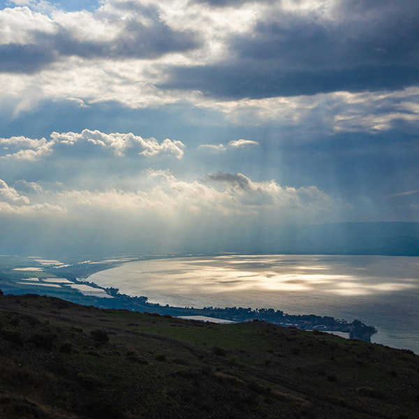 sun shining through clouds on the Sea of Galilee