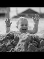 a boy playing in a sandpile