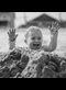 a boy playing in a sandpile