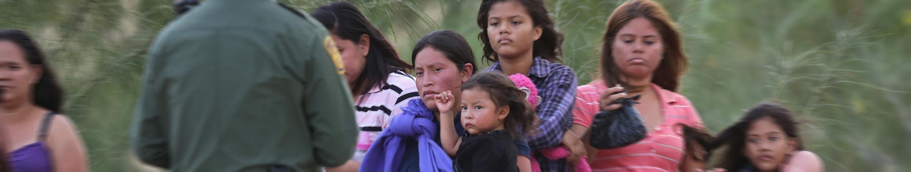 US agents take undocumented immigrants into custody near the Texas-Mexico border, July 2014