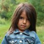 girl holding red leaf