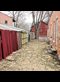 red wooden fence between two buildings
