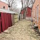 red wooden fence between two buildings