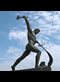 sculpture of a man beating a sword with a hammer