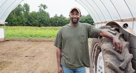 Richard Joyner standing next to a tractor.