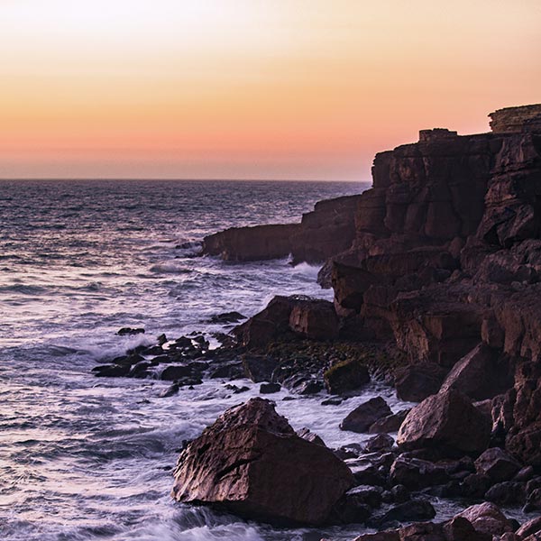 sunset over a rugged coast