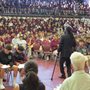 Hashim Garrett addressing an auditorium filled with attentive students