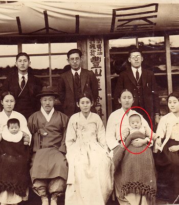 The author with his mother and family on his first birthday, 1933.